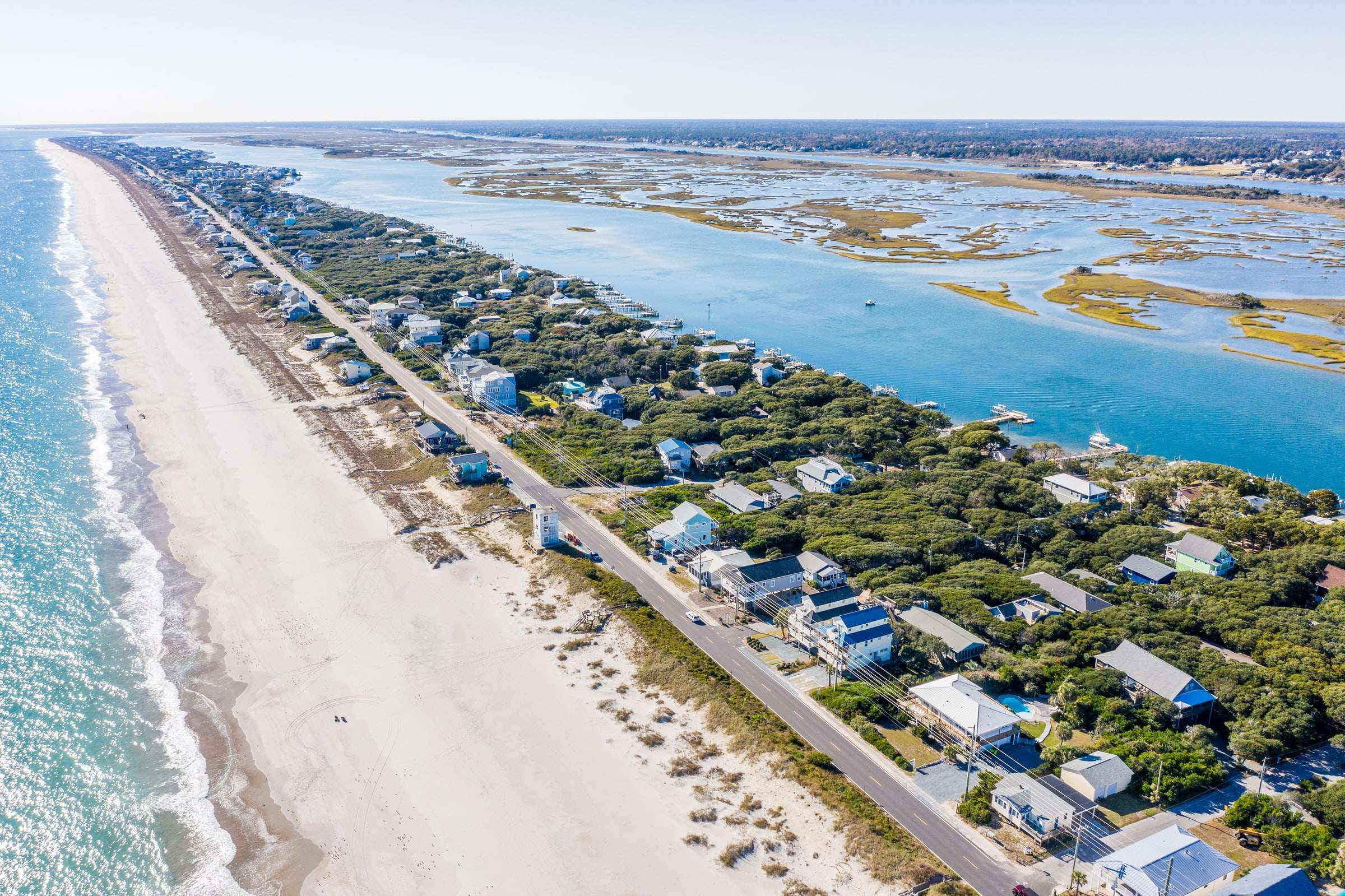 Aerial view of Topsail Island in Surf City, NC with the Atlantic Ocean on one side and the sound on the other