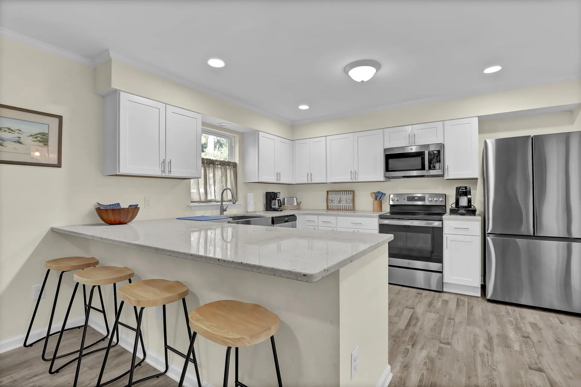 White kitchen with counter-height seating for four