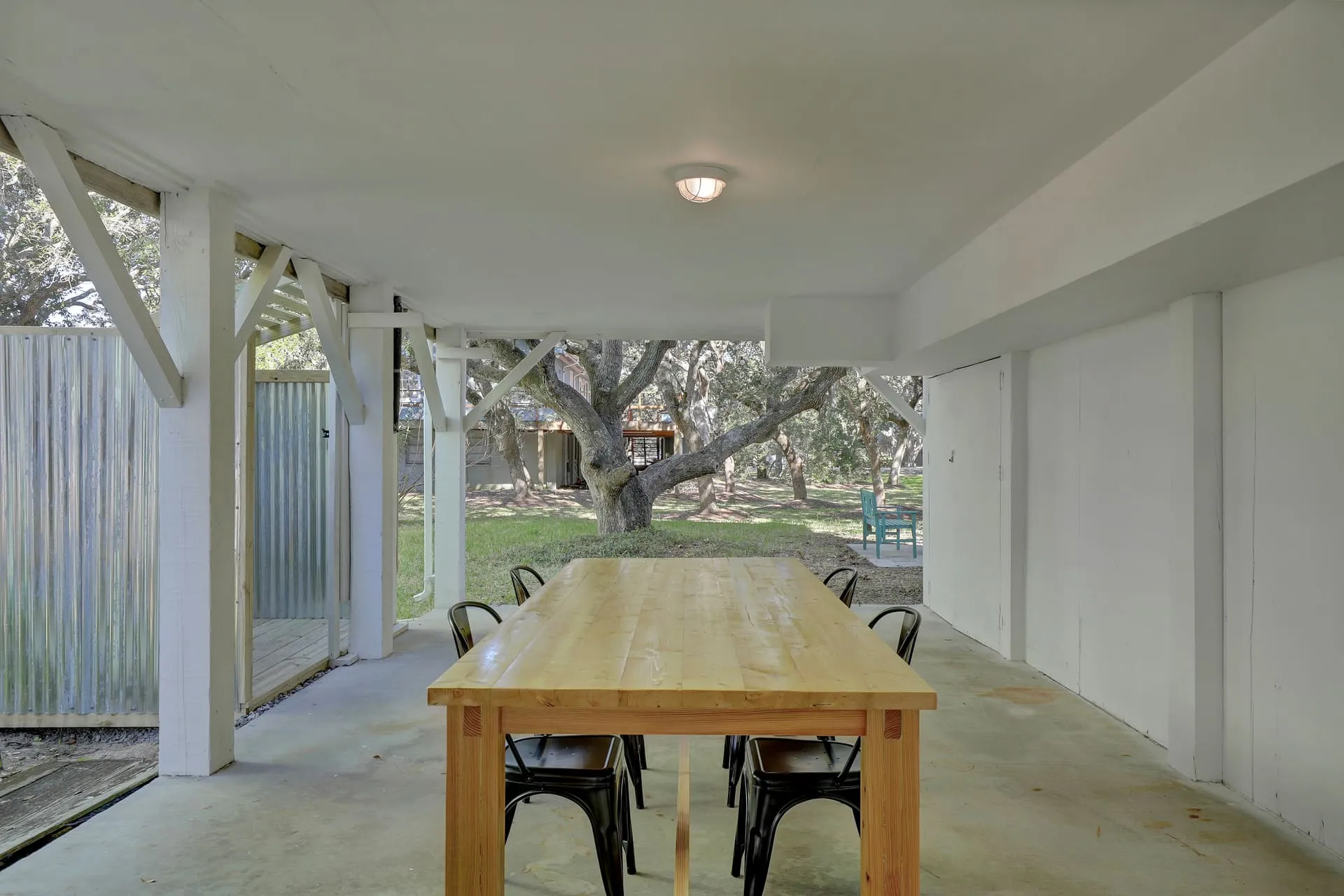Shaded outdoor dining table under the house
