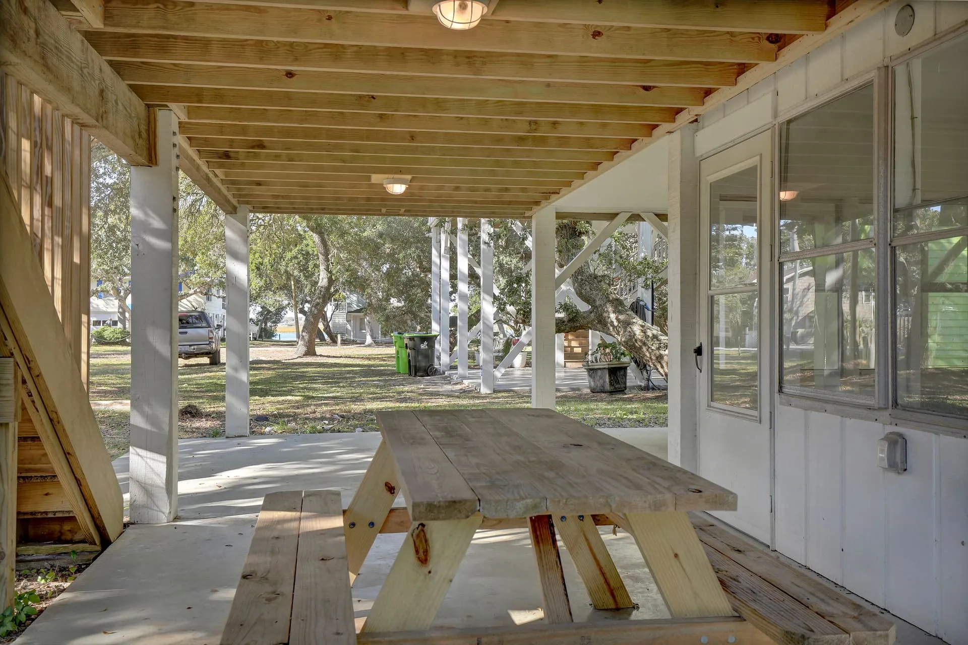 Picnic table under the house by the sun porch door