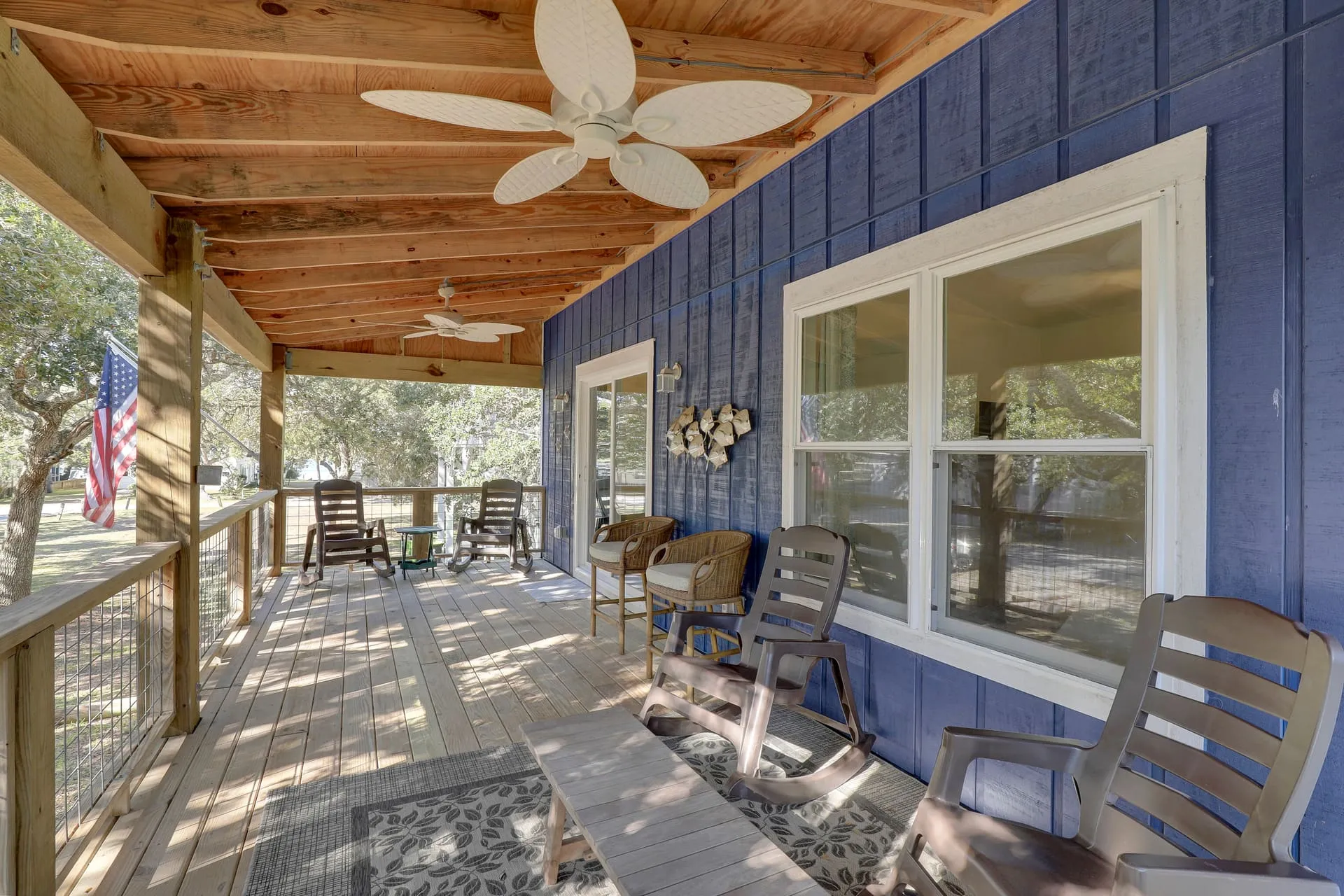 Covered front porch with rocking chairs and ceiling fans